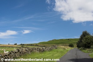 Road leading uphill on north side of Chairford Bridge.